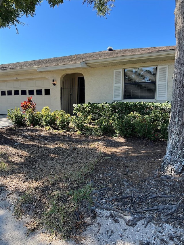 ranch-style house with an attached garage and stucco siding