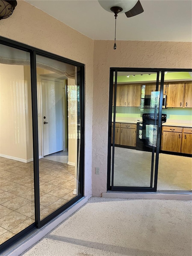 property entrance with a patio area and ceiling fan