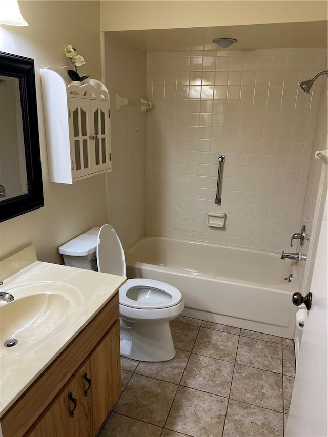 full bathroom featuring tile patterned flooring, vanity, tiled shower / bath combo, and toilet