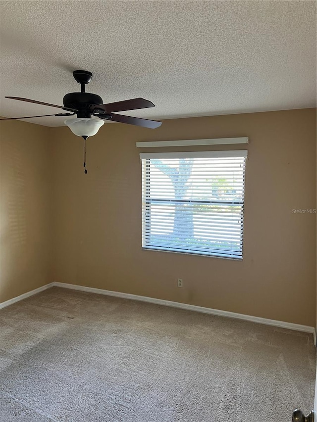 carpeted empty room with a textured ceiling