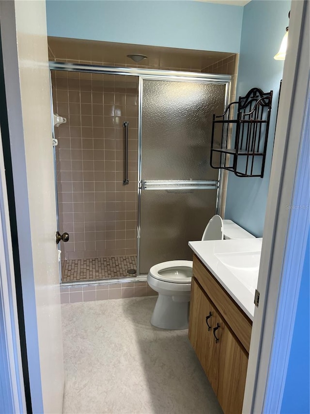 bathroom featuring vanity, toilet, and walk in shower