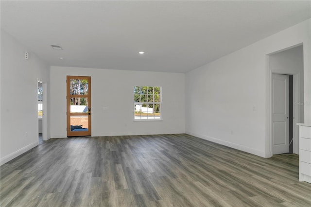 spare room featuring wood-type flooring