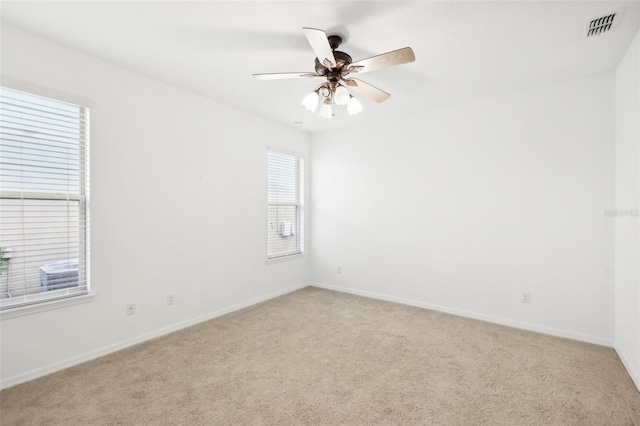 spare room featuring ceiling fan and light colored carpet