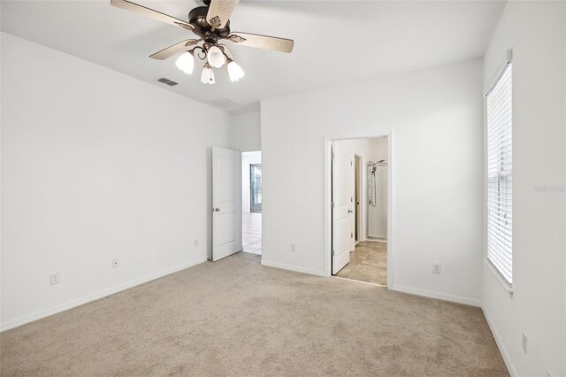 unfurnished bedroom with light colored carpet and ceiling fan