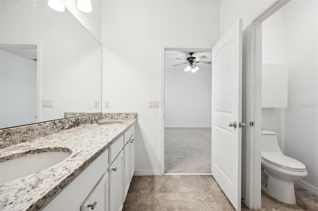 bathroom with ceiling fan, toilet, and vanity