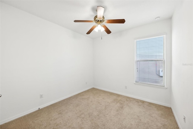 carpeted spare room with ceiling fan