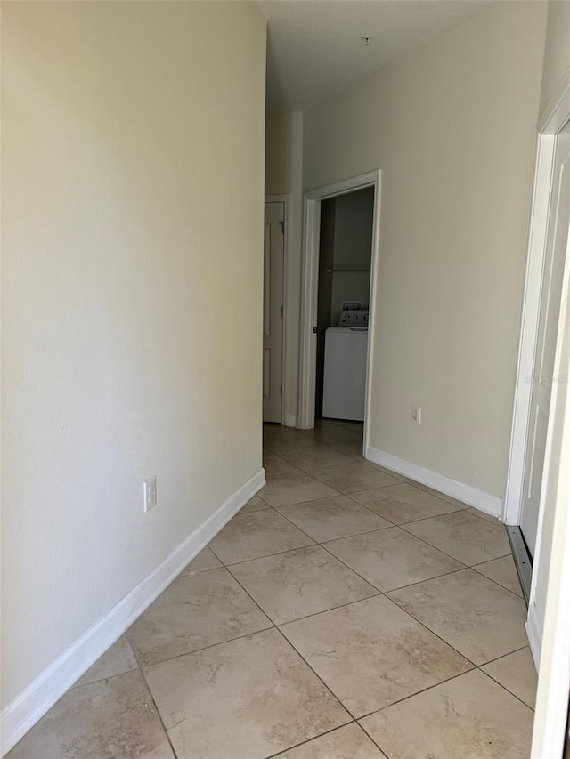 interior space featuring light tile patterned flooring and washer / dryer