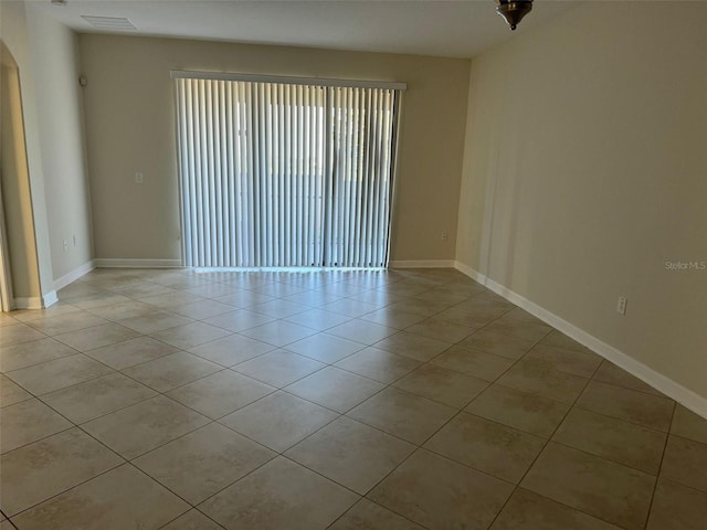 tiled empty room featuring plenty of natural light