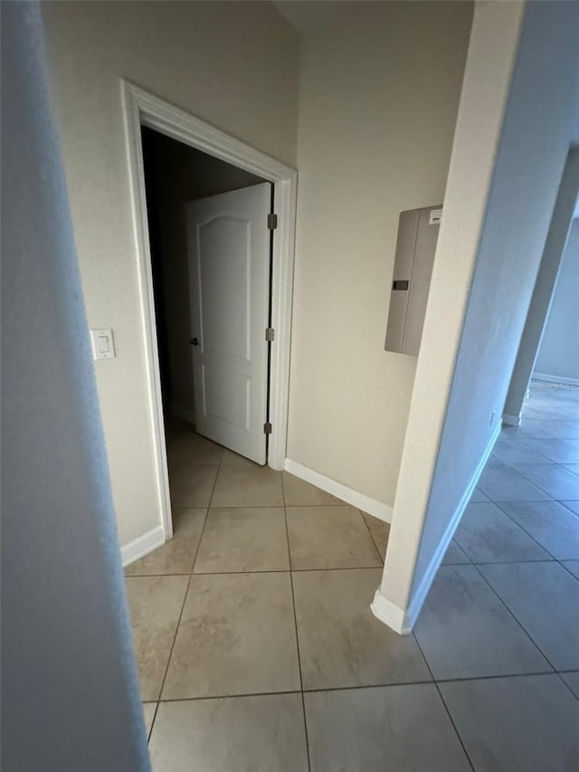 hall featuring light tile patterned floors