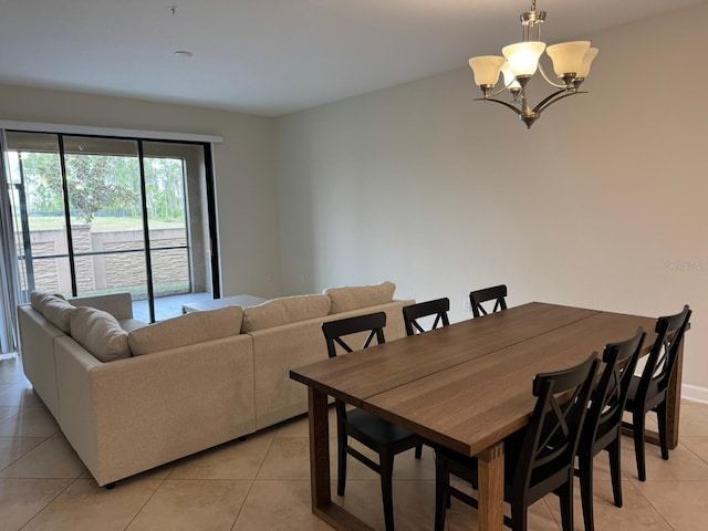 dining room with an inviting chandelier and light tile patterned floors