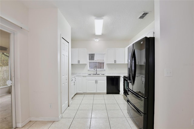 kitchen with black appliances, white cabinets, sink, a textured ceiling, and light tile patterned flooring