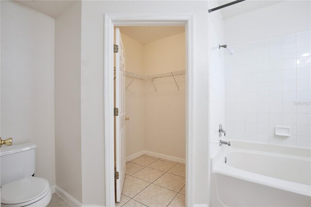 bathroom with tile patterned flooring, toilet, and shower / bathtub combination