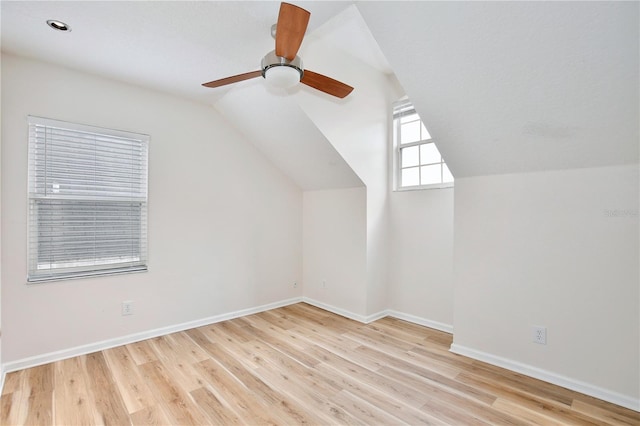 bonus room featuring light hardwood / wood-style floors, ceiling fan, and lofted ceiling