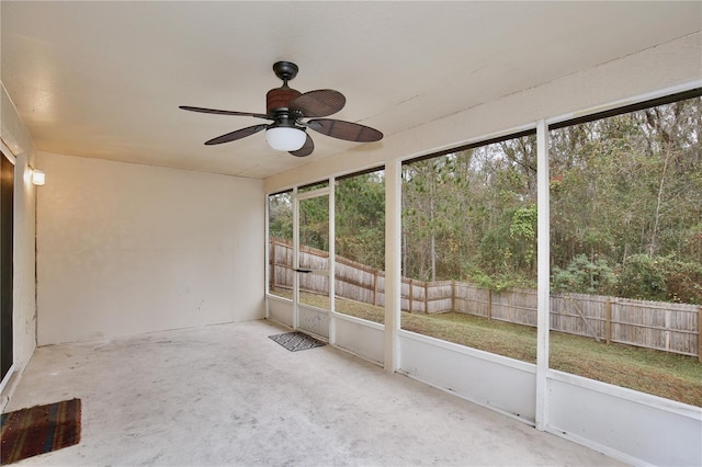 unfurnished sunroom featuring ceiling fan