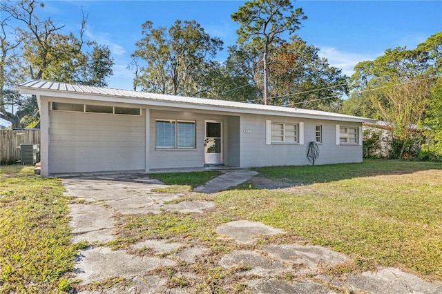 ranch-style house featuring central air condition unit and a front lawn