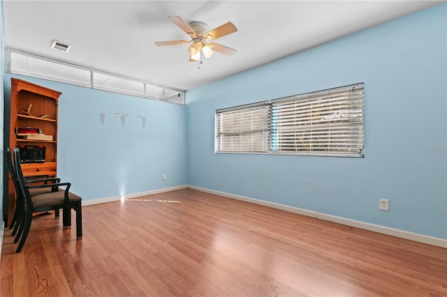 spare room featuring ceiling fan and light hardwood / wood-style floors