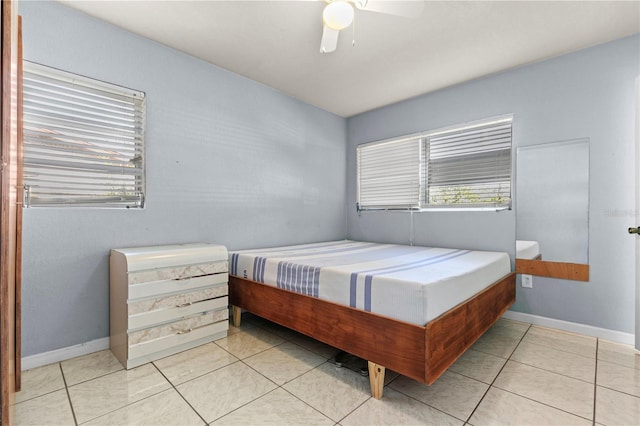 bedroom with ceiling fan and light tile patterned flooring