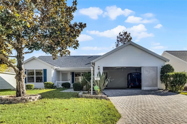 ranch-style house featuring a porch, a front yard, and a garage