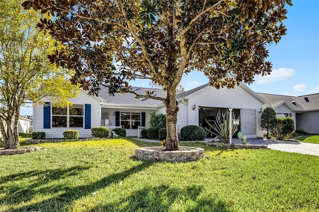 view of front of house with a garage and a front yard