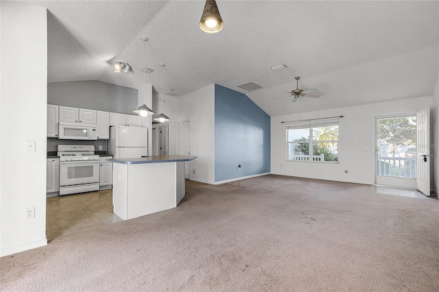 kitchen with white appliances, ceiling fan, white cabinets, a kitchen island, and lofted ceiling