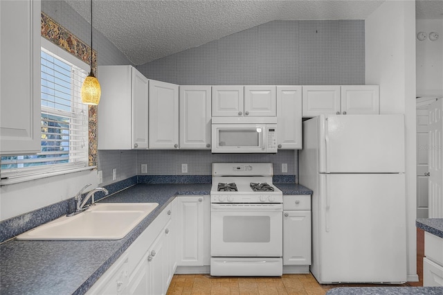 kitchen with a textured ceiling, white appliances, vaulted ceiling, and sink