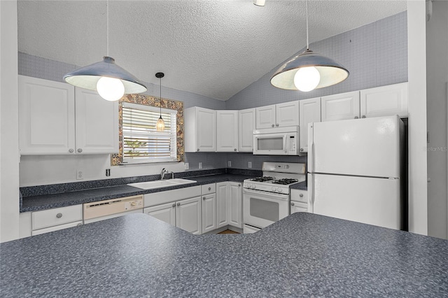 kitchen with sink, pendant lighting, lofted ceiling, white appliances, and white cabinets