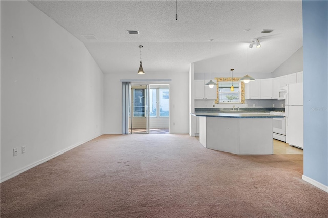 kitchen with white appliances, light carpet, decorative light fixtures, a kitchen island, and white cabinetry