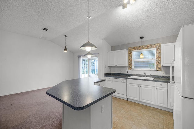 kitchen featuring white cabinets, a healthy amount of sunlight, white appliances, and lofted ceiling