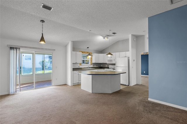 kitchen featuring pendant lighting, a center island, white appliances, vaulted ceiling, and white cabinetry