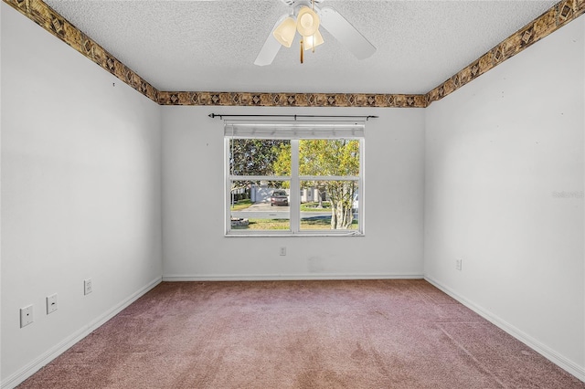 carpeted spare room with ceiling fan and a textured ceiling