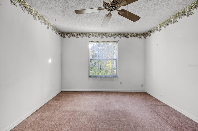 carpeted spare room featuring ceiling fan and a textured ceiling