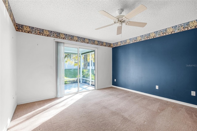 spare room with carpet flooring, ceiling fan, and a textured ceiling