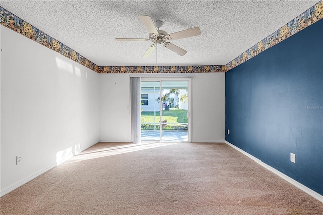 empty room featuring carpet flooring, ceiling fan, and a textured ceiling