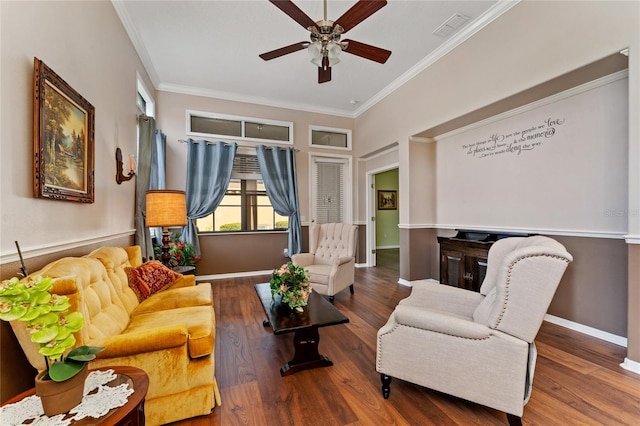 living room featuring hardwood / wood-style floors, ceiling fan, and ornamental molding