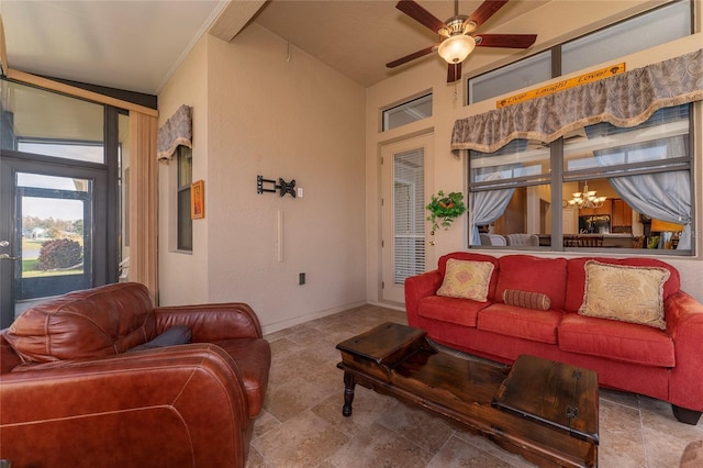 living room featuring ceiling fan with notable chandelier and vaulted ceiling