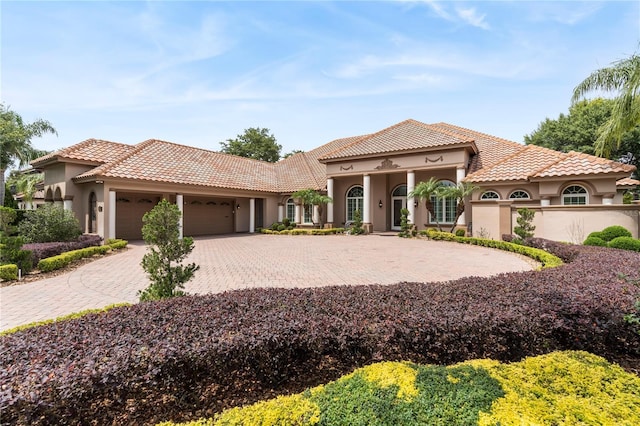 mediterranean / spanish home featuring a garage