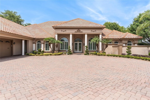 mediterranean / spanish-style home with a garage