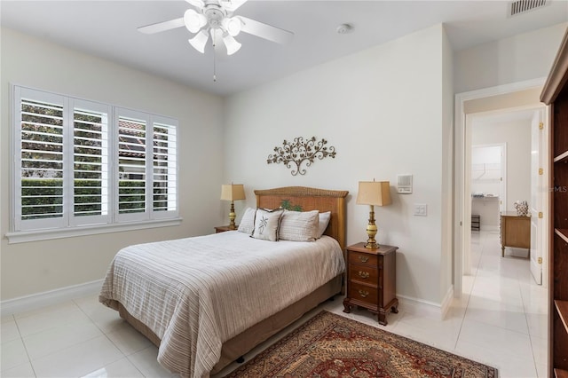 bedroom with ceiling fan and light tile patterned floors