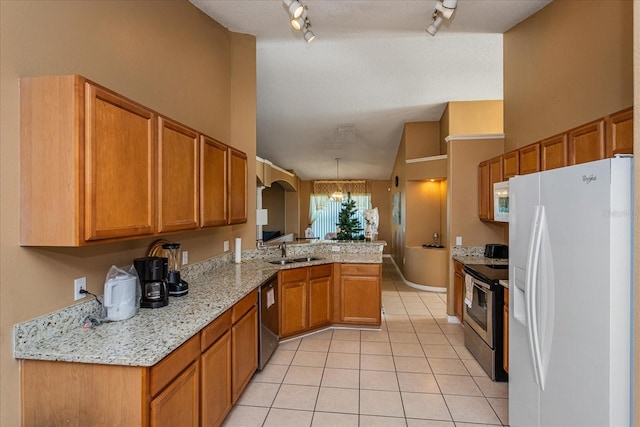 kitchen featuring sink, rail lighting, stainless steel appliances, kitchen peninsula, and a chandelier