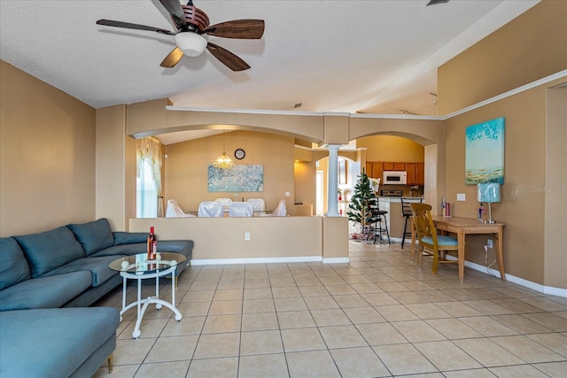 living room featuring a textured ceiling, ceiling fan, light tile patterned floors, and vaulted ceiling