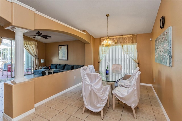 dining area featuring ornate columns, light tile patterned floors, and ceiling fan with notable chandelier