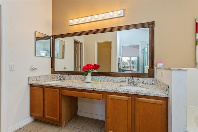 bathroom with a tub, tile patterned flooring, and vanity