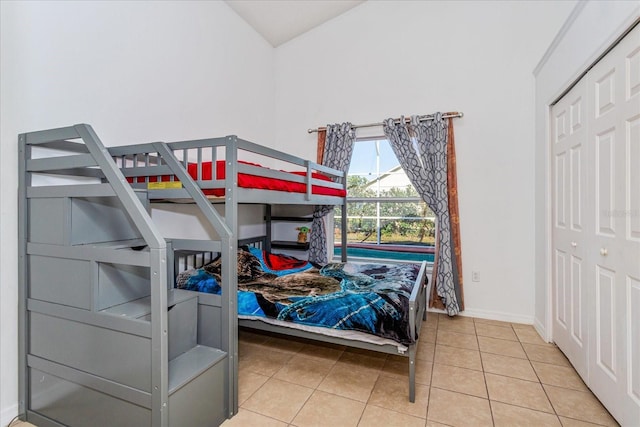 tiled bedroom with a closet