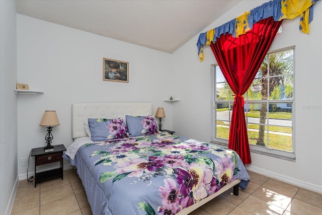 tiled bedroom with vaulted ceiling and a textured ceiling