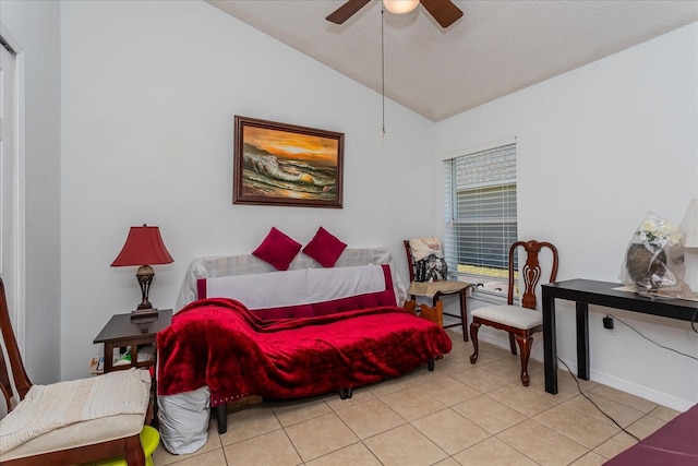 bedroom with ceiling fan, light tile patterned floors, a textured ceiling, and vaulted ceiling