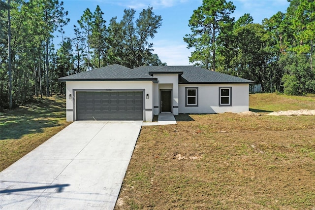 view of front of home featuring a front yard and a garage