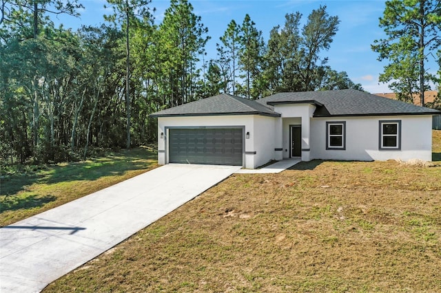 view of front of house with a garage and a front lawn