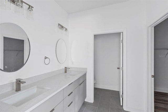 bathroom featuring tile patterned flooring, vanity, and toilet