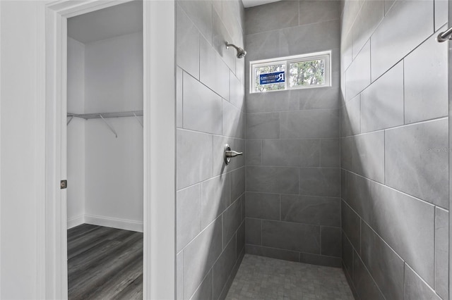 bathroom with hardwood / wood-style floors and tiled shower