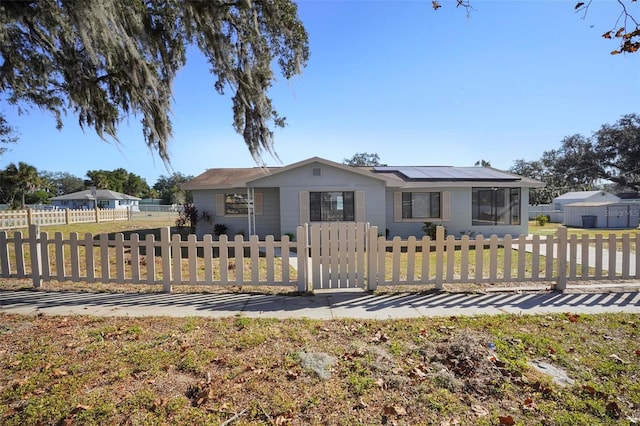 view of front of property featuring solar panels